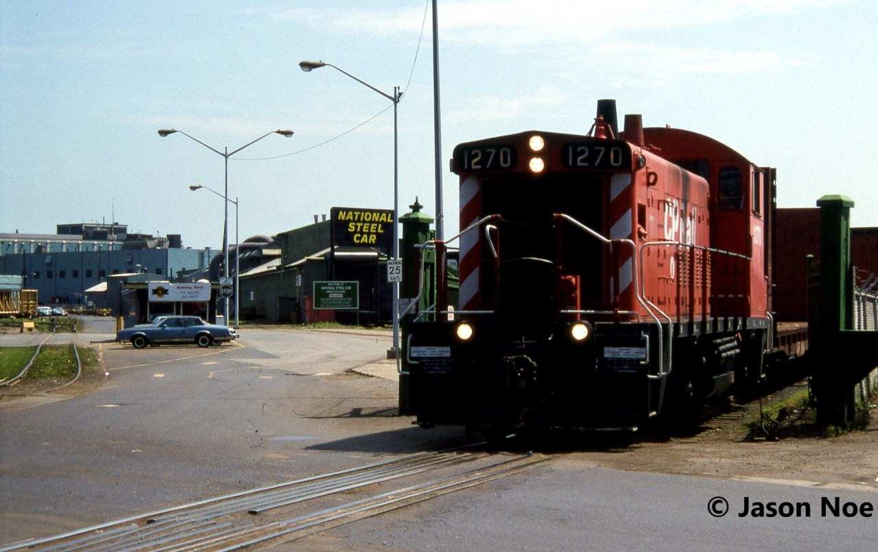 During a sweltering July day, CP SW1200RSm 1270 (ex-CP 8150) works the National Steel Car facility deep in the industrial core of Hamilton, Ontario. CP 1270 was retired in October 2003 and was sold to Rail Trusts Equipment (RTEX). The unit was later resold to the St. Marys Railroad in Georgia and was repainted and renumbered to 506.