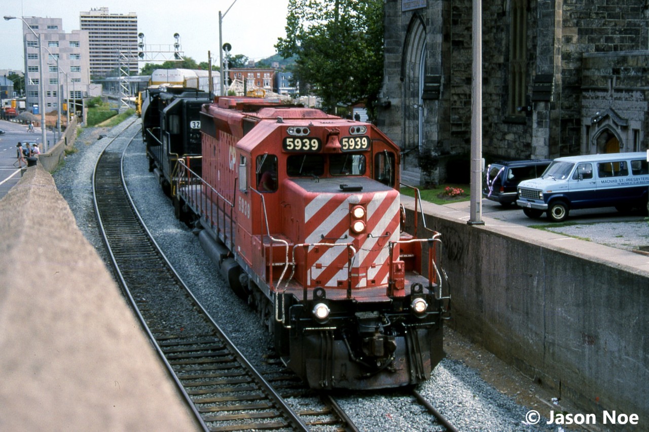A northbound CP train with SD40-2 5939 and SD40-2 3254 are pictured about to enter the Hunter Street tunnel in downtown Hamilton, Ontario on the Hamilton Subdivision. CP 3254, is ex-NS 3254, nee-Southern Railroad 3254. It would later be renumbered to CP 5485 and was eventually sold to National Railway Equipment.