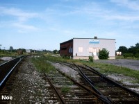 During the mid-90’s, Cobourg, Ontario’s long closed Canadian Pacific Express & Transport regional freight warehouse building still stood as part of the railway scene situated along the Belleville Subdivision almost frozen in time. It was located across from the interchange tracks with CN’s parallel Kingston Subdivision where the lone boxcar is pictured. Eventually it was slated for demolition by CP, however in 1996, it was purchased by a company named Legacy. Over time, they fully repaired and revived the neglected building and adjoining property into a thriving building materials and antique collectables business. Today it serves as Legacy Vintage’s warehouse, while the small yard beside the original CP express building has since been removed. 
