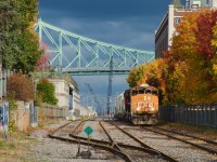CN 500 is leaving the Port of Montreal under storm clouds as it passes some fall colours with CN 4765 leading.