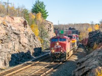 Here's a Sudbury rock cut in the daylight! Six months since the merger, it's become a near-daily occurrence to see CP and KCS power paired up on cross-country intermodals. Under the low autumn sun, CPKC 119 navigates the Sprecher s-bend at a leisurely pace – it first has to let the eastbound Budd car enter the double track at Flanagan, about a mile up the track.