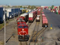 Two of the three GEs are freshly painted ET44ACs as CPKC 112 leaves Lachine IMS Yard with autoracks.