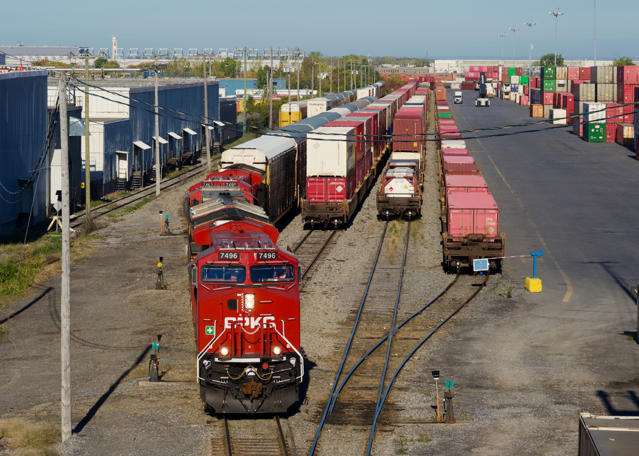 Two of the three GEs are freshly painted ET44ACs as CPKC 112 leaves Lachine IMS Yard with autoracks.