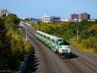 GO 561 leads 3516 from Mount Pleasant - Union through the West Toronto neighbourhood, about to pass under Rogers Road.  In the distance, the new Mount Dennis GO Station can be seen, which when finished, will connect GO and Union Pearson passengers with TTC and Eglinton Crosstown LRT systems.  <br><br>The large white building at centre is part of the <a href=http://www.trainweb.org/oldtimetrains/industrial/history/kodak_aerial_2.jpg>former Kodak plant,</a> located on the northeast side of Eglinton Avenue and Weston Roads, east of the CNR Brampton Sub and CPR Mactier Sub.  Named Kodak Heights, the plant, commencing operation in 1917 as Kodak's Canadian headquarters, was expanded in 1939 when building 9, pictured above, was built.  Operation continued until June 2005, when Kodak ceased its Canadian operations.