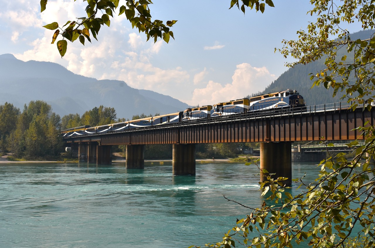 Wandering the BC interior always means a stop at Revelstoke, whether its to check the CP yard, to visit the museum, or hang out near the bridge since it usually produces some satisfying photo opportunities.  On this last visit, I elected to park my butt at the bridge which spans the Columbia River (or, as this portion is called "Upper Arrow Lake") and hope for something interesting.
Wish I had known there was a morning work block out there. Beautiful weather for 3 hours and then the clouds began their approach. I'm guessing nothing holds up the Rocky Mountaineer, so it was the first train toward Revy and it is seen here crossing the bridge around 1240. Lead unit is 8013 but I missed the numbers on the follow 2 units. There must have been 20 cars on this train. Very impressive !!!! The destination is Banff.