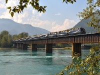 Wandering the BC interior always means a stop at Revelstoke, whether its to check the CP yard, to visit the museum, or hang out near the bridge since it usually produces some satisfying photo opportunities.  On this last visit, I elected to park my butt at the bridge which spans the Columbia River (or, as this portion is called "Upper Arrow Lake") and hope for something interesting.
Wish I had known there was a morning work block out there. Beautiful weather for 3 hours and then the clouds began their approach. I'm guessing nothing holds up the Rocky Mountaineer, so it was the first train toward Revy and it is seen here crossing the bridge around 1240. Lead unit is 8013 but I missed the numbers on the follow 2 units. There must have been 20 cars on this train. Very impressive !!!! The destination is Banff.