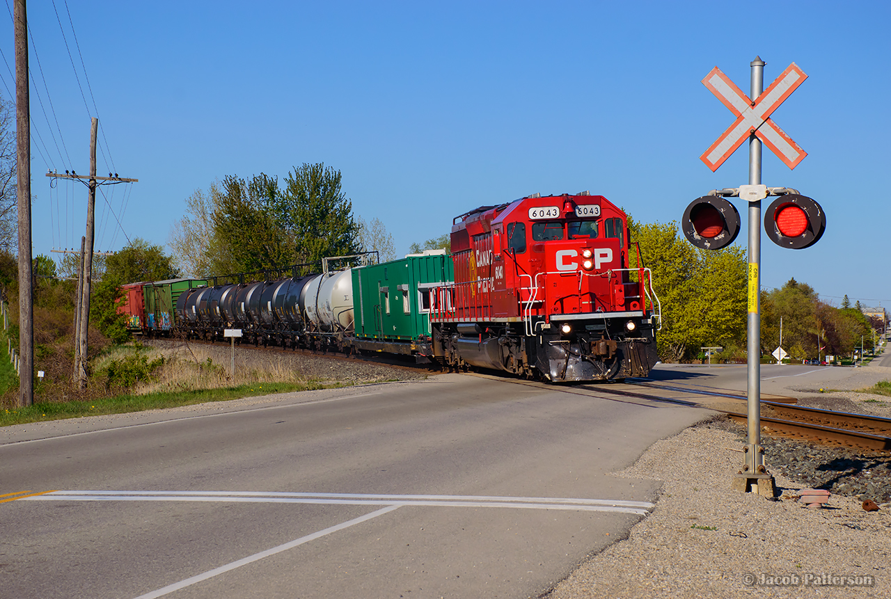 Working west along the Galt Sub, CPKC's weed spray train rounds the curve out of Drumbo.