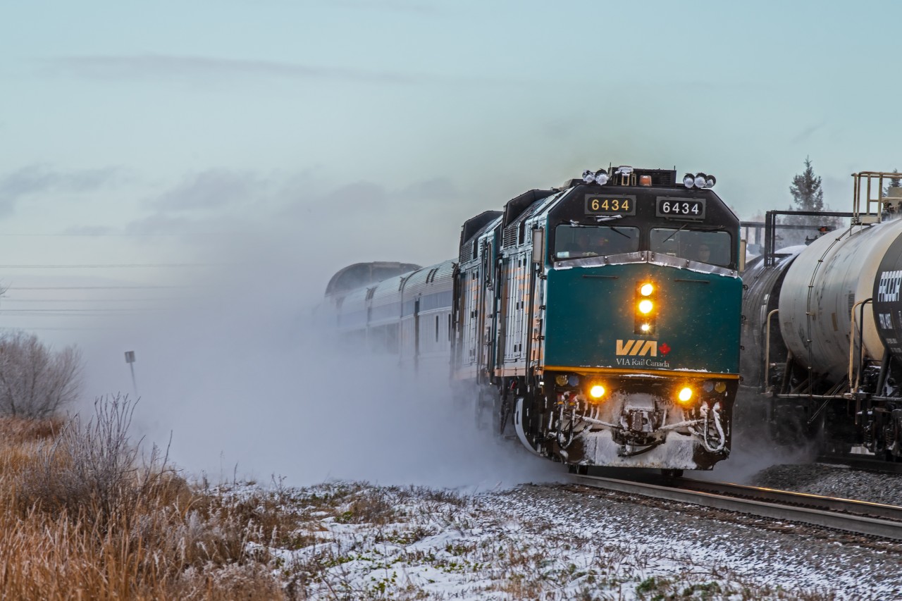 Picking speed, and picking up snow... VIA 693 is in the early stages of their long journey to Churchill Manitoba.