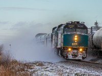 Picking speed, and picking up snow... VIA 693 is in the early stages of their long journey to Churchill Manitoba.