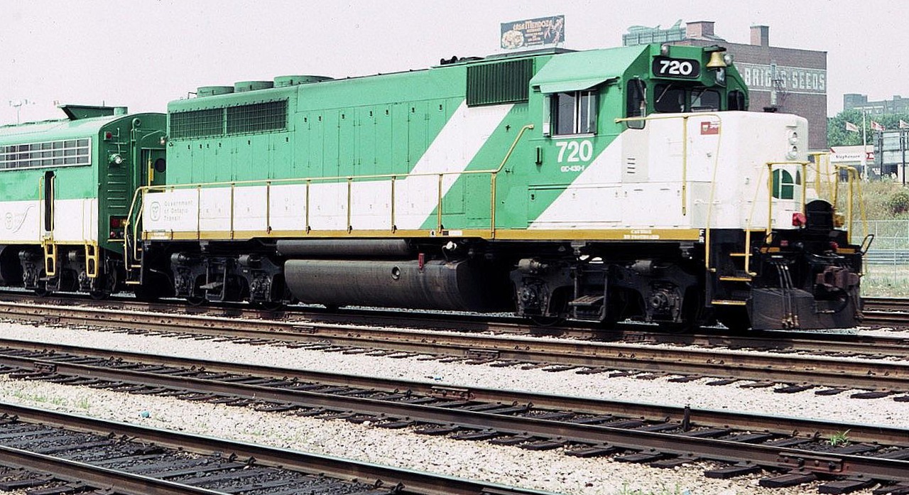 GO Transit 720 leads an eastbound inbound commuter train towards Toronto Union Station in August of 1983. This unit was a rebuilt EMD GP-40 classified as a GP-40-2M