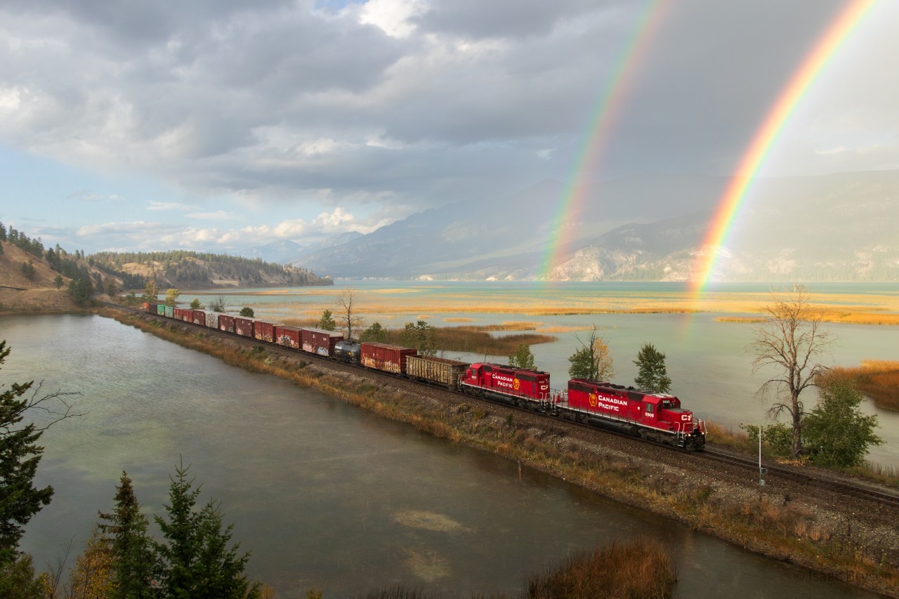 Well I finally learned what the pot of gold at the end of a rainbow is. CP A19, the Golden-Trail wayfreight soars through Canal Flats in the pouring rain with SD40-2 pair 5905 & 5973 leading. SD40s, mountains, and rainbows; what more could you ask for?
