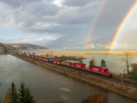 Well I finally learned what the pot of gold at the end of a rainbow is. CP A19, the Golden-Trail wayfreight soars through Canal Flats in the pouring rain with SD40-2 pair 5905 & 5973 leading. SD40s, mountains, and rainbows; what more could you ask for?