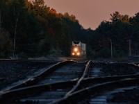 The sun is just catching the treetops, there's frost on the ties, and just a touch of fog lurking as another of CN's many daily stack trains winds out of the Parry Sound sink heading for Toronto.