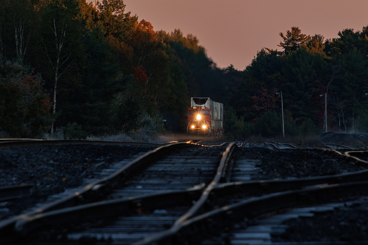 The sun is just catching the treetops, there's frost on the ties, and just a touch of fog lurking as another of CN's many daily stack trains winds out of the Parry Sound sink heading for Toronto.