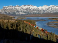 CN X 19991 08 races along the Athabasca River, as another beautiful day in Jasper National Park draws to a close. 

X 19991 08: CN 3815, CN 3881 – DP 1x1x0 – 166 cars
