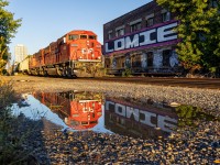 <b>Old Toronto</b>
<br>
With alarms set in the early morning hours to see if H17 will be daylight in Toronto, I get a call from a friend saying that they are lined down the Mactier sub, about an hour before sunrise. Unfortunately, the train was already approaching Elder as I got on the subway to attempt a searchlight shot on the Belleville.
So, I went to the closest spot to not risk missing the train in the morning light, which was at Bartlett.
This was my first time back at Bartlett since the signals were cut over, and the scene definitely felt different. But the buildings beside the road still give the spot some photographic value, along with the puddle to make the shot even better.