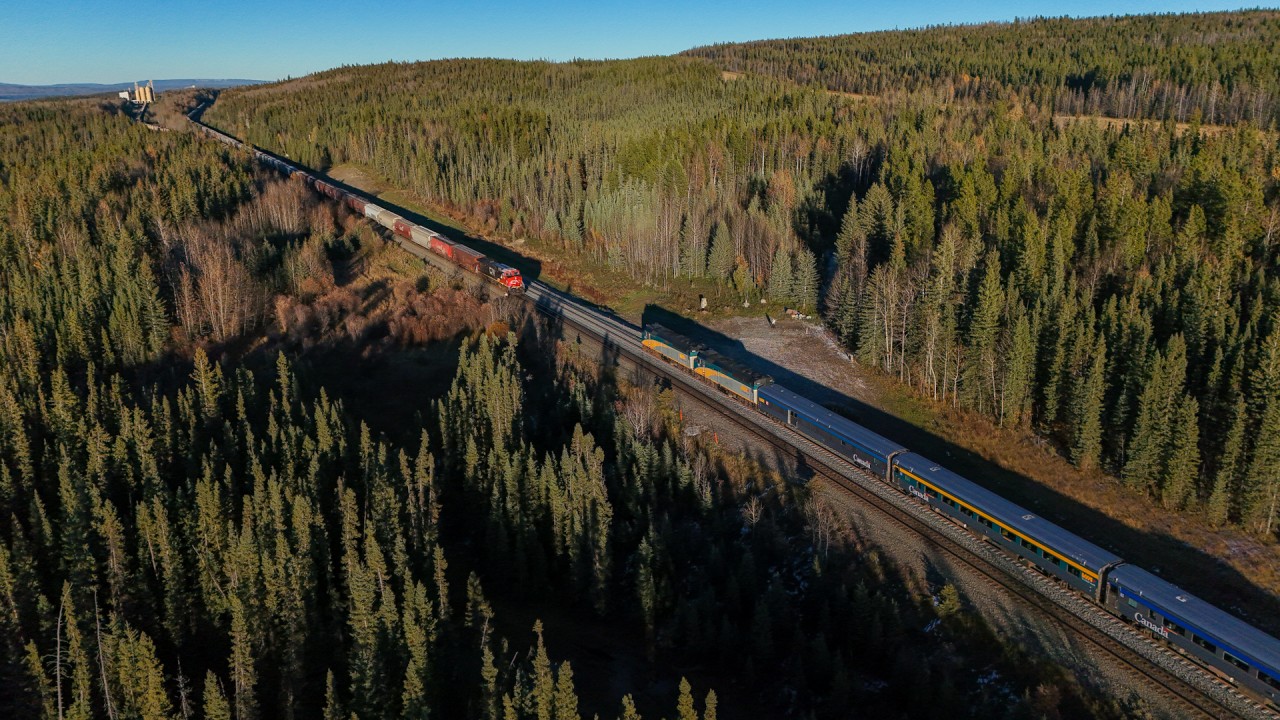 “A long forgotten, lonely cairn of stones” - Lyrics from Stan Rogers’ song “Northwest Passage” came to mind while awaiting the arrival of VIA’s Canadian at Dalehurst, Alberta.  You may recognize the name, as the location of the 1986 Hinton disaster, where the eastbound Super Continental, collided head-on with CN 413, on the single track just west of Dalehurst.  23 people died and 71 were injured in the incident, likely caused by medical distress and crew fatigue.  This led to major changes to the Canadian railway industry with new rest rules for trains crews and reset safety controls being mandated on locomotives.  39 years later, nature has reclaimed the derailment site, with no visible scars on the land; the only reminder is a small trackside monument, visible behind the conductor of CN G 87541 12.  With no public access, a long forgotten, lonely cairn of stones is all that remains to commemorate the tragedy that occurred nearly two decades ago in the foothills of Alberta.
