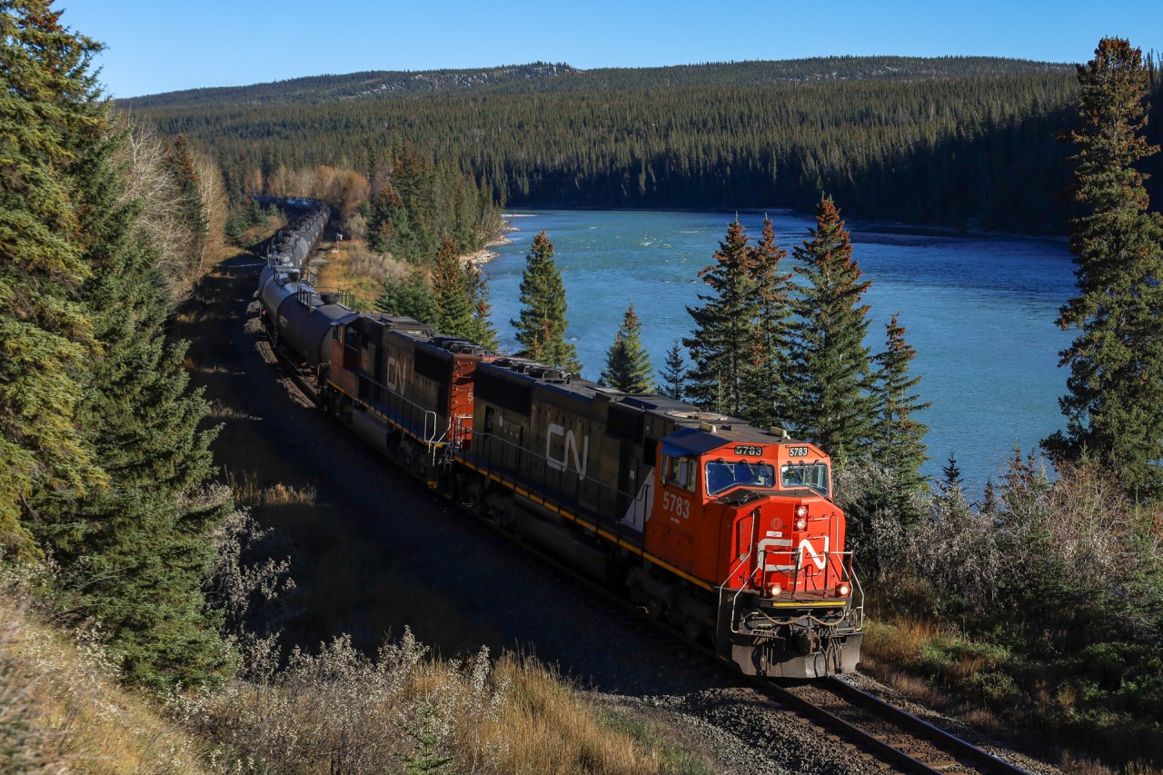 Classic power (for 2025!) leads a 98 car LPG train along the shores of the Athabasca River, as U 76151 13 transitions from the foothills to the Rocky Mountains.