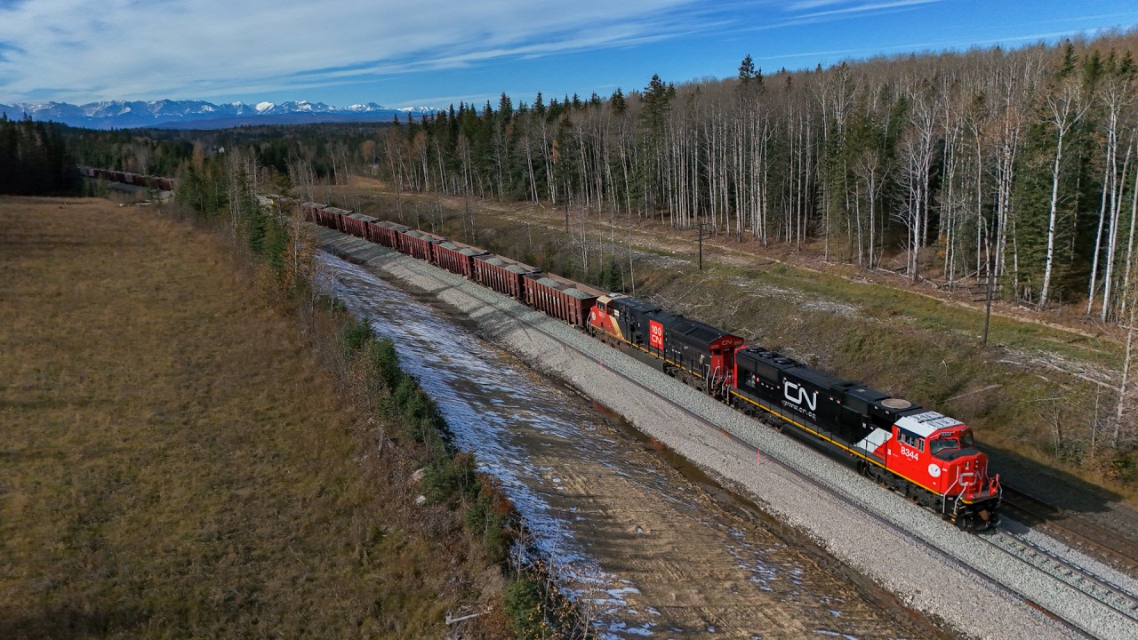 New power, newer track.  Brand new CN 8344 is relegated to work train service, handling an 88 car Herzog ballast train from McAbee Pit on the Ashcroft Sub.  W 90451 15 is sitting on the “construction track” between Dalehurst and Pedley, part of the major double tracking project on the Edson Sub, which will see double track extended between Hargwen and Galloway and Dalehurst and Pedley.  This will alleviate the most serious capacity constraint in Western Canada, as trains work towards the Obed Summit.  Don’t believe me?  Go watch a 30,000 ton grain train grind up the mountain through Medicine Lodge at 0.45HPT on the single track!