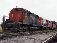 Power for the grain train out of Midland sits tied down in the yard waiting for its next trip south to Toronto.  Once grain traffic is lifted <a href=https://www.railpictures.ca/?attachment_id=53752>from the large elevators in town,</a>the consist will be on the move to lift stone traffic from the <a href=https://www.railpictures.ca/?attachment_id=52839>Uhtoff Quarries,</a> before heading for <a href=https://www.railpictures.ca/?attachment_id=48634>the Newmarket Sub</a> at Midland Jct. in Orillia.

<br><br><i>Scan and editing by Jacob Patterson.</i>