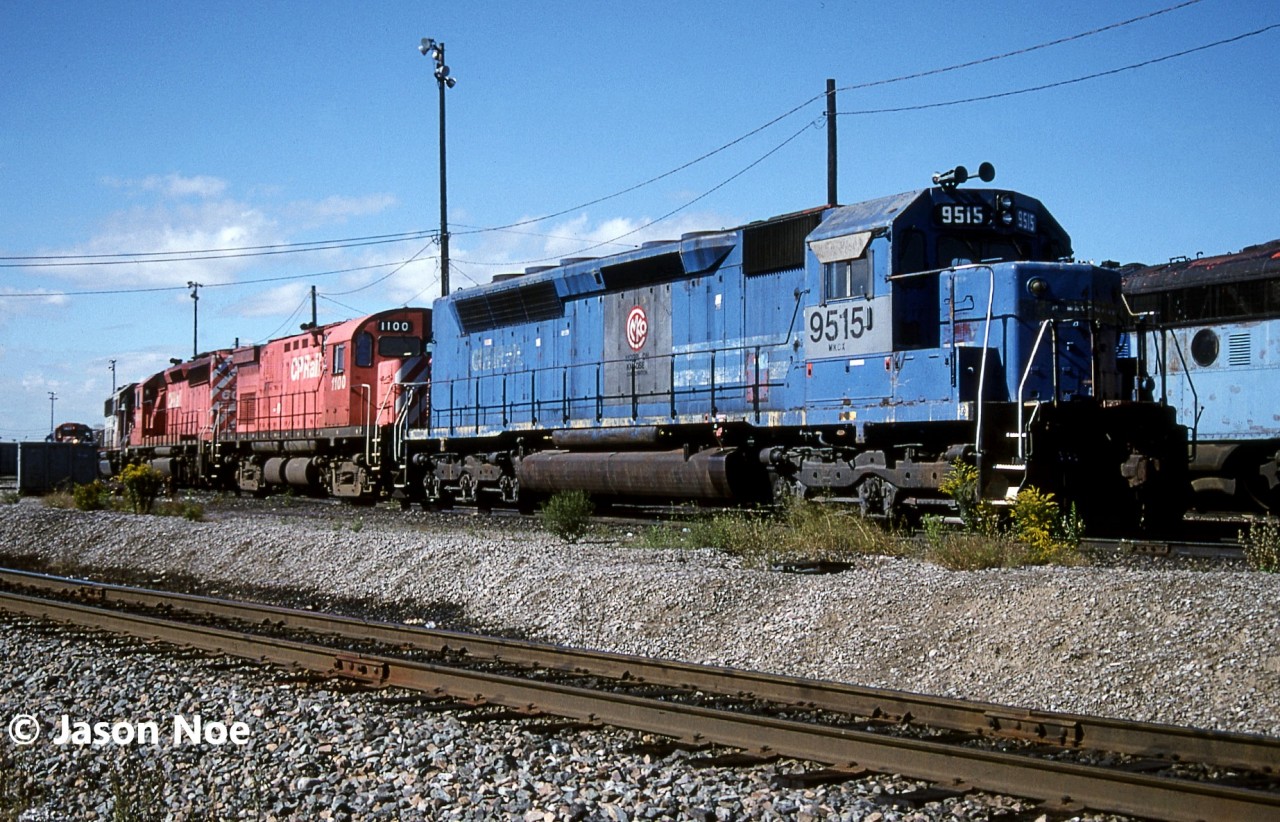 In August 1970, SDP45 3664 was delivered new to the Erie Lackawanna Railroad and eventually became Conrail 6695 following the formation of big blue. Post retirement it became VMV Enterprises (VMVX) 6695, then later Morrison Knudsen Corporation (MKCX) 9515 remaining in its Conrail blue colours. During the 90’s several members of the EL SDP45 fleet were rebuilt into new SD40M-2’s by Morrison Knudsen for Southern Pacific. 9515 seemed to have eluded this rebuilding program and instead became part of the great CP lease fleet of the mid-90’s. Where it went after its lease to CP someone on here might know as the trail seems to have gone cold. However, decades later, Athearn Genesis did do an HO model of it in this same version.

Here on a September morning, MKCX 9515 along with CP Control Cab 1100 and SD40-2 6043 wait between assignments at CP’s Toronto Yard diesel shop.