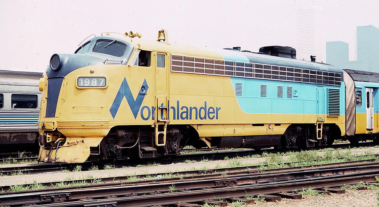 Ontario Northland FP7A 1987 is seen between runs at the coach yard near Toronto Union Station in August of 1983. The Toronto skyline is seen beyond in the summer haze. Lots of details visible for modelers of the old F units.