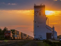 The trail end of a CN train heading East through Dugald Manitoba right after the summer sunrise.