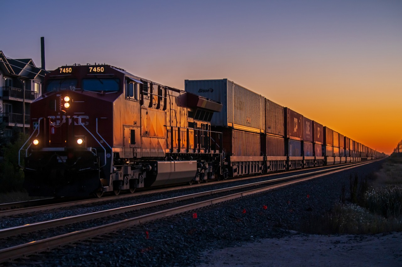 As the sun rises in Eastern Winnipeg. CPKC 7450 leads their intermodel train into town.