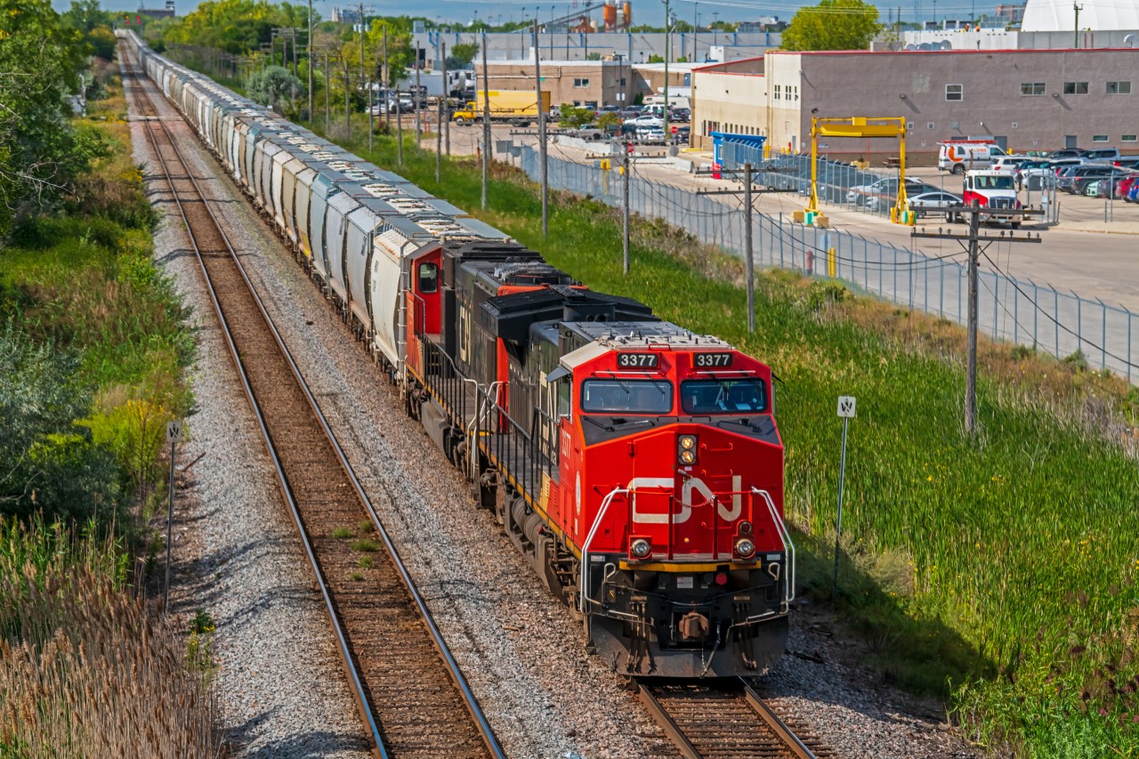 Dragging a miles worth of grain hoppers into Symington Yard.