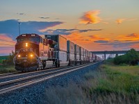 A freshly painted CPKC 7513 lead a long intermodel train into Winnipeg during a fall sunrise.