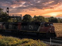 An early CN A425 crawls past the Paris West countryside and under the old signal tower at the beginning of the yard. An un-rebuilt CN SD70i is in the lead, which is also a treat. The sun also put on a show for the shot.