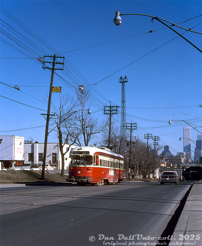 TTC PCC 4324 (A6 class, CC&F 1947) climbs the dip from under the King Street railway underpass, heading westbound at Atlantic Ave. on a King streetcar run for Dundas West Station. One of CPR's Parkdale Yard lighting towers is visible near the tracks, as well as the usual downtown Toronto office towers beyond. On the left were the Consolidated Fastfrate offices (note the rear of a "CF" trailer), that were once located at the upper part of CP's Parkdale Yard, before they moved to the new shed/warehouse along St. Clair Avenue at Runnymede.

Original photographer unknown, Dan Dell'Unto collection slide.