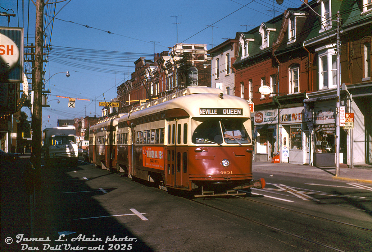 TTC PCC 4651 (ex-Cleveland A11-class, built by Pullman in 1946) heads eastbound on Queen Street West, operating in MU with another A11-class PCC on the busy Queen route approaching Bathurst Street. The low-rise Victorian storefronts advertise furniture, appliances, Yukon Variety and Fineberg's Deli. An old Neilson's Dairy delivery truck is in the curb lane unloading.

James L. Alain photo, Dan Dell'Unto collection slide.