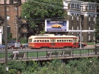 TTC 4351 is in Toronto in August 1986. The billboard makes an interesting contrast to the PCC.