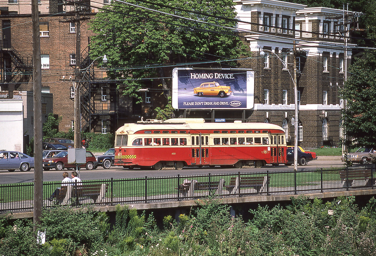 TTC 4351 is in Toronto in August 1986. The billboard makes an interesting contrast to the PCC.