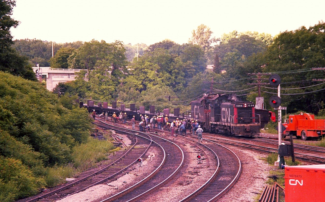 I can't help it, but when I look over this photo, an old time song which begins with "Hail, hail, the Gangs all Here" goes through my head.  There must be 30 bodies out there busy at trackwork right at the junction. It is a wonder they do not trip over each other. How times have changed. CN 1256 and 1318 power the work train.