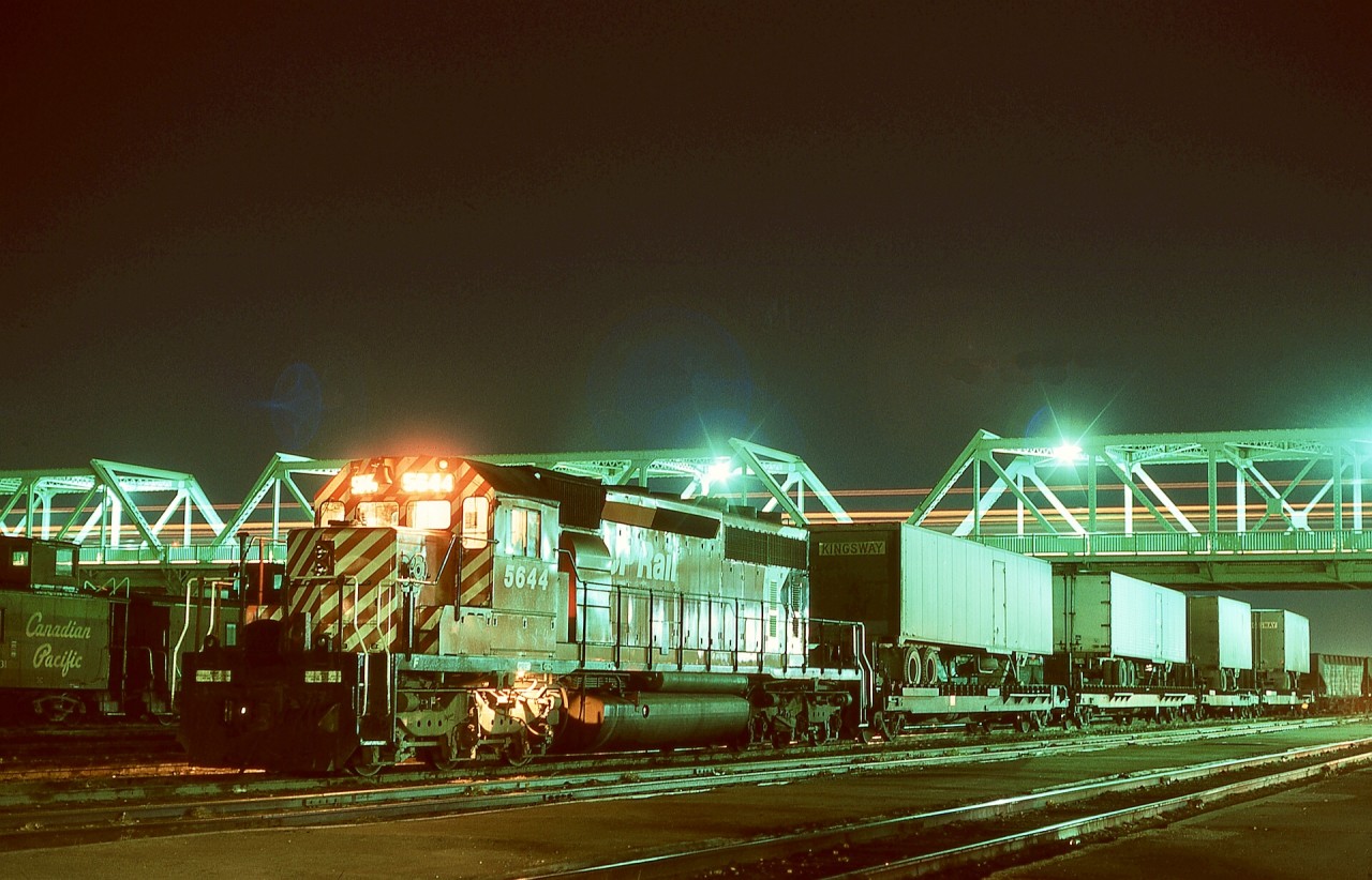 Before CP Lethbridge was relocated west in 1984 to Coalhurst (later Kipp), Lethbridge yard was in downtown, and was overpassed near the depot by a roadway (Stafford Drive, as far as I recall).  In the evening of Tuesday 1974-10-15, westward hotshot connection from Dunmore running as train number 79 with SD40-2 CP 5644,  bound for Union Pacific interchange at Kingsgate, BC, paused for crew change.  Today, the mainline has been relocated 270 metres north, but the depot survives at 801 on 1 Avenue South, with MLW 2-8-0 CP 3651 on display nearby.