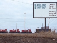 Hard to believe how the time is going by. It has already been almost 45 years since this sign was erected at Agincourt yard announcing 100 Years of the Canadian Pacific.
In the background, moving freight around the yard are diminutive (by today's standards) are GMD SW9 switchers, 7403, 7401 and 7404. 
