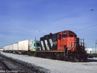 One of the short-lived Eco-Rail trains sits in Malport Yard. These trains ran overnight between Toronto and I believe Drummondville, Quebec. For a very short period of time they may have run with only the Eco-Rail truck / locomotive before CN starting putting a locomotive in the lead. 