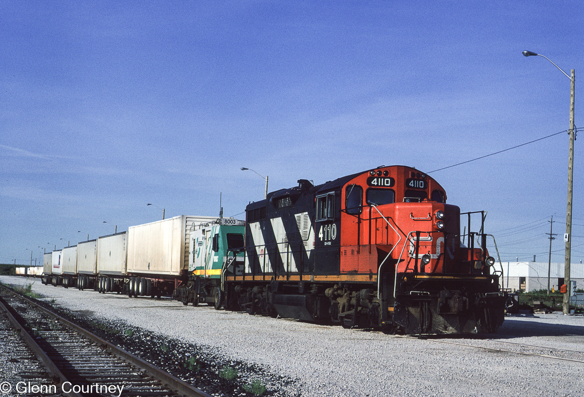 One of the short-lived Eco-Rail trains sits in Malport Yard. These trains ran overnight between Toronto and I believe Drummondville, Quebec. For a very short period of time they may have run with only the Eco-Rail truck / locomotive before CN starting putting a locomotive in the lead.