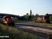 CN GP9RM 4142 and SW1200RSm 7105 are catching the first morning light of the day at the CN yard in Niagara Falls, Ontario. In later years, 7105 became CANAC Leasing (CANX) 7105 and was sent to the US to work at a Cargill facility in Bridgeport, Iowa. CN 4142 was retired in August 2001. 