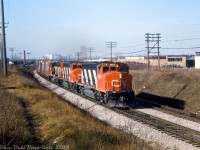 Matching zebra-striped CN GP40-2LW's 9602, 9597 and 9593 head up an eastbound auto parts train, rolling around the curve on the Kingston Sub at Birchmount Avenue near where the GECO Branch came off the mainline.
<br><br>
<i>Mike Mastin photo, Dan Dell'Unto collection slide.</i>