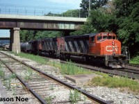CN train 449 is photographed working Stuart Street Yard in Hamilton, Ontario. This was a regular MacMillan Yard to Niagara Falls train that normally worked Stuart Street yard in the morning. The consist included; SD40-2(W) 5348, M-636 2338 and GP9RM 4107. 