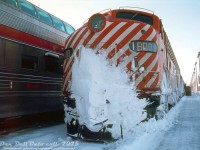 CP Rail E8 1800 looks like she's seen more than her fair share of snow drifts on the trip to Windsor Station, sitting on the head end of recently arrived train #41, The Atlantic Limited, along the station platforms. On the next track over, Banff Park trails on the tail end of the next #1 (The Canadian) due out of Montreal.<br><br><i> Original photographer unknown, Dan Dell'Unto collection slide.</i>