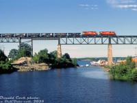 Crossing high above the Parry Sound harbour area, CP Rail C424 4212 and GP30 5001 (note the <a href=http://www.railpictures.ca/?attachment_id=42072><b>Ogden multimark!</b></a>) head up a northbound ballast train over the trestle on the Parry Sound Sub.
<br><br>
<i>Donald Cook photo, Dan Dell'Unto collection slide.</i>