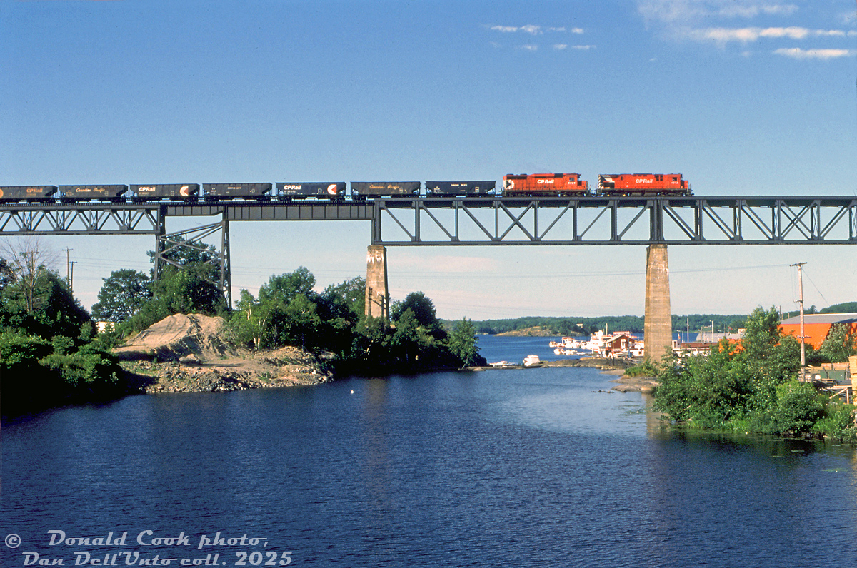 Crossing high above the Parry Sound harbour area, CP Rail C424 4212 and GP30 5001 (note the Ogden multimark!) head up a northbound ballast train over the trestle on the Parry Sound Sub.

Donald Cook photo, Dan Dell'Unto collection slide.