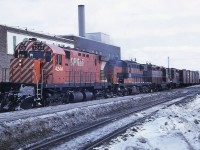 CP C-424 4244 leads B&LE 881 and a pair of GP9s, 8807 and 8671, westbound over the Elm Street crossing in downtown Sudbury on February 21, 1970. The true colours of winter are evident in the photo.