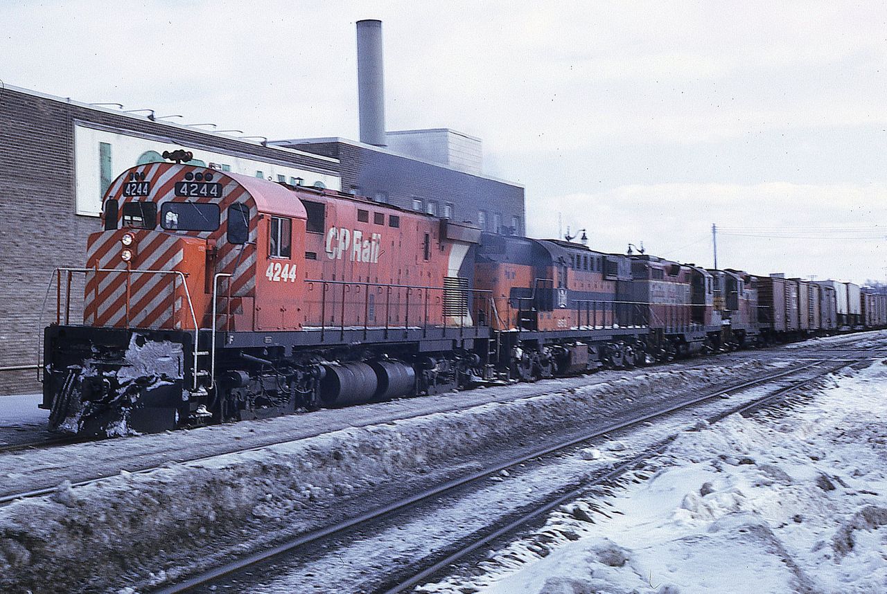 CP C-424 4244 leads B&LE 881 and a pair of GP9s, 8807 and 8671, westbound over the Elm Street crossing in downtown Sudbury on February 21, 1970.  The true colours of winter are evident in the photo.