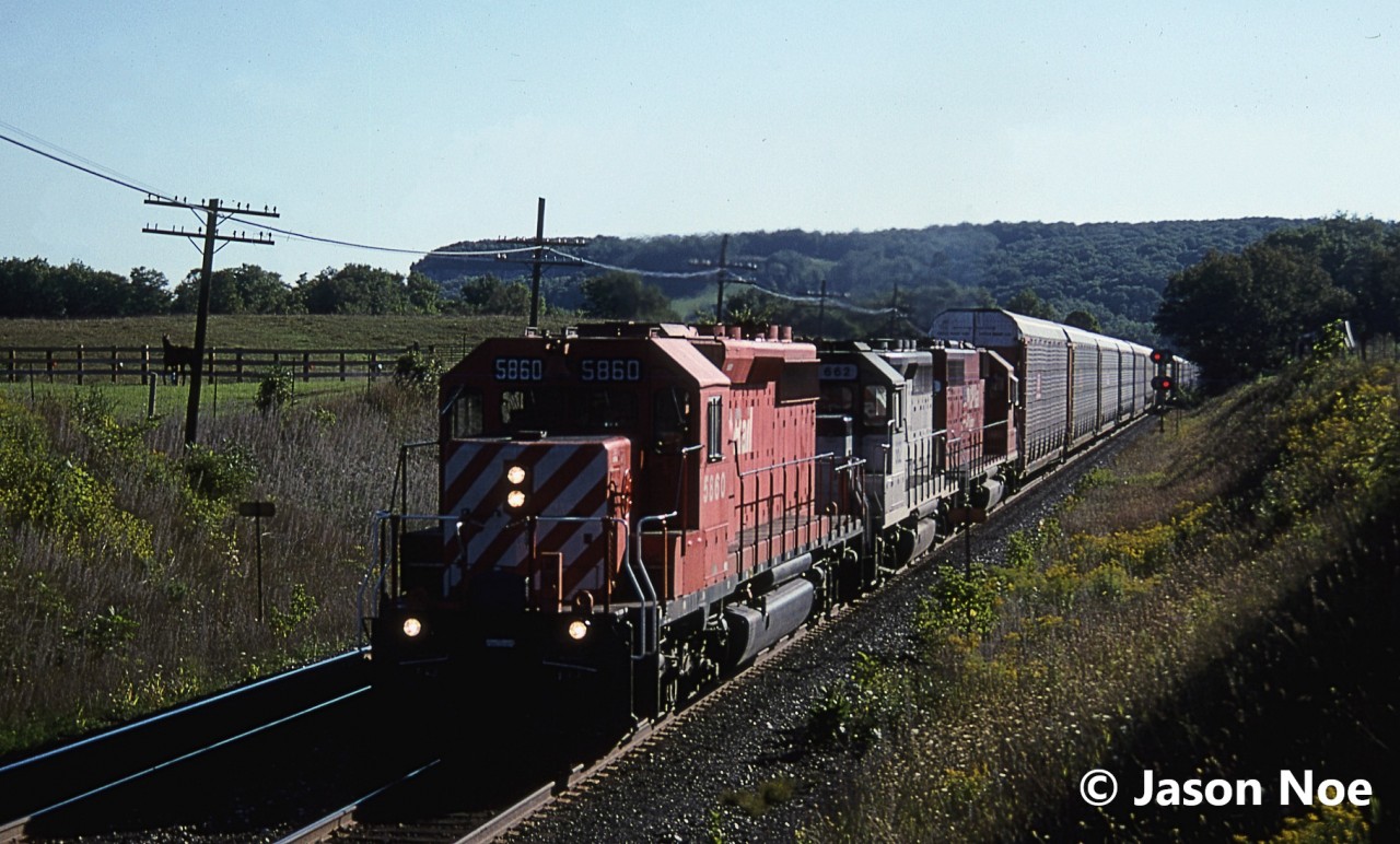 A horse watches as a morning westbound CP train approaches Canyon Road, east of Campbellville, Ontario at Mile 37 on the Galt Subdivision. Light was certainly not as favorable compared to the eastbound we were waiting for, however in the 90’s during the CP lease fleet era, every train was usually worthy of one photo. The consist included; SD40-2 5860, HLCX GP40 662 and CP SD40 740. HLCX 662 was ex-Amtrak 662, ex- SOO Line 2007 and nee-Milwaukee Road 2007.