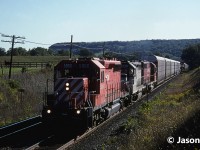 A horse watches as a morning westbound CP train approaches Canyon Road, east of Campbellville, Ontario at Mile 37 on the Galt Subdivision. Light was certainly not as favorable compared to the eastbound we were waiting for, however in the 90’s during the CP lease fleet era, every train was usually worthy of one photo. The consist included; SD40-2 5860, HLCX GP40 662 and CP SD40 740. HLCX 662 was ex-Amtrak 662, ex- SOO Line 2007 and nee-Milwaukee Road 2007.